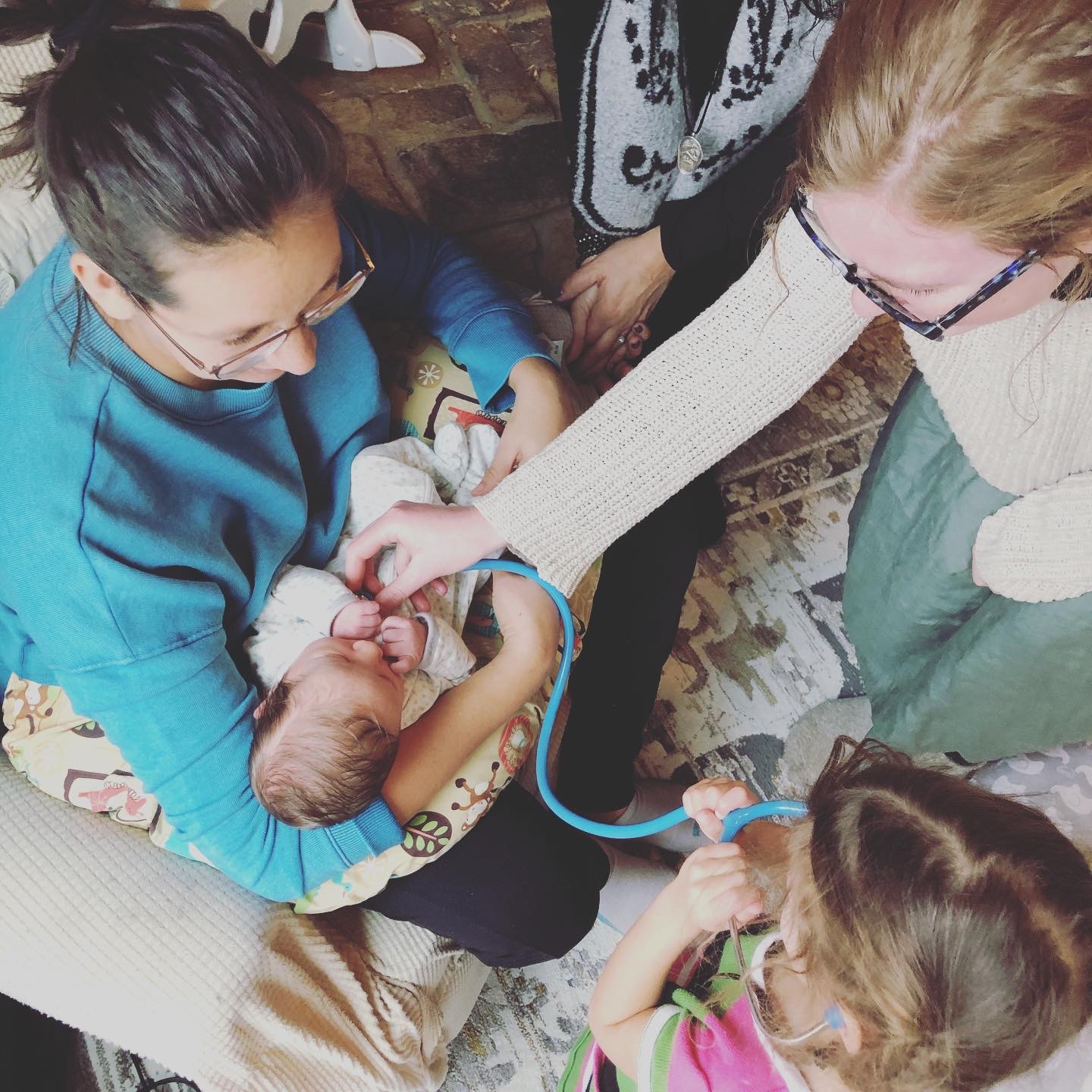 Family participating in medical care of baby